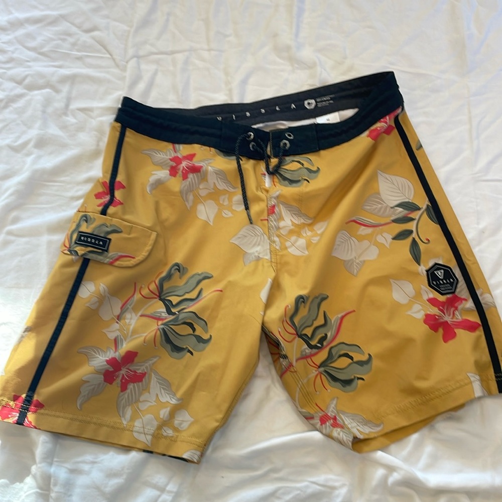 Videos board shorts. Mustard yellow color with flowers.